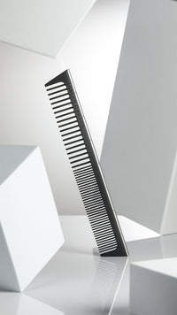 A premium Joseph Orozco Measuring PRO Hair Comb is featured in a portrait orientation, displaying its finely crafted teeth and ergonomic handle for precision in hair styling, against a stark white background that emphasizes the comb's sleek and professional design.